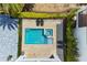 Aerial of sparkling pool, spa, lush landscaping, and stylish outdoor furniture at 1543 Corolla Ct, Reunion, FL 34747