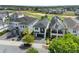 Aerial view of a modern home in a golf course community, featuring dark roof and well-kept landscaping at 1543 Corolla Ct, Reunion, FL 34747