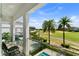 Scenic view from the balcony overlooking a golf course with palm trees and a hot tub at 1543 Corolla Ct, Reunion, FL 34747