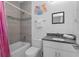 Well-lit bathroom with tub-shower combo, granite counters, and fun princess-themed wall decor at 1543 Corolla Ct, Reunion, FL 34747