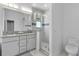 Bathroom featuring double vanity, glass shower, and decorative blue tile accent at 1543 Corolla Ct, Reunion, FL 34747