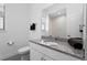Clean bathroom with granite counters, modern toilet, and bright, natural light at 1543 Corolla Ct, Reunion, FL 34747