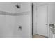 Modern bathroom features shower with mosaic accent tiles and sleek fixtures at 1543 Corolla Ct, Reunion, FL 34747