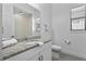 Bright bathroom with a granite countertop vanity, sleek fixtures, and a modern commode at 1543 Corolla Ct, Reunion, FL 34747