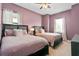 Bedroom featuring two beds, soft carpet and lavender colored walls at 1543 Corolla Ct, Reunion, FL 34747