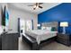 Bright bedroom with access to a balcony, contemporary decor, and a sleek TV at 1543 Corolla Ct, Reunion, FL 34747