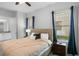 Comfortable bedroom features a large bed, natural light from window, and neutral color scheme at 1543 Corolla Ct, Reunion, FL 34747