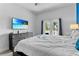 Inviting bedroom with a balcony view and a mounted flatscreen TV at 1543 Corolla Ct, Reunion, FL 34747