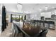 Dining room with chandelier lighting and open access to the kitchen and backyard pool at 1543 Corolla Ct, Reunion, FL 34747