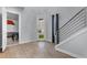 Bright foyer with modern staircase, light wood floors, and view into adjacent room at 1543 Corolla Ct, Reunion, FL 34747