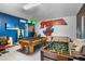 Entertainment room with pool table, foosball, tv, and vibrant wall decor with superhero themes at 1543 Corolla Ct, Reunion, FL 34747