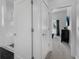 Hallway with access to bathroom with tiled shower and modern design elements, leading to the bedroom at 1543 Corolla Ct, Reunion, FL 34747