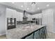 Modern kitchen with stainless steel appliances, granite countertops, and island with bar seating at 1543 Corolla Ct, Reunion, FL 34747