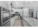 Modern kitchen features stainless appliances, granite countertops, island, and recessed lighting at 1543 Corolla Ct, Reunion, FL 34747