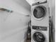 Laundry room includes stacked washer and dryer and wire shelving at 1543 Corolla Ct, Reunion, FL 34747