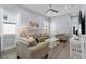 Cozy living room with neutral tones, ceiling fan, stylish furniture, and lots of natural light at 1543 Corolla Ct, Reunion, FL 34747