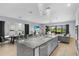 Open concept kitchen and dining area with outside view of swimming pool at 1543 Corolla Ct, Reunion, FL 34747