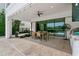 Spacious covered patio features an outdoor kitchen and dining area at 1543 Corolla Ct, Reunion, FL 34747