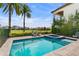 Serene pool with spa overlooking the golf course with lounge chairs at 1543 Corolla Ct, Reunion, FL 34747