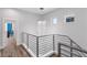 Modern staircase with sleek metal railing and chandelier, adding a touch of elegance to the home at 1543 Corolla Ct, Reunion, FL 34747