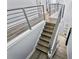 Stylish staircase with metal railings and wood steps, providing a modern and open feel to the home at 1543 Corolla Ct, Reunion, FL 34747