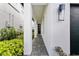 Inviting covered walkway leading to the front door, featuring elegant white pillars and manicured landscaping at 1543 Corolla Ct, Reunion, FL 34747