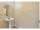 Simple half-bath with pedestal sink and neutral wall color at 16217 Saint Augustine St, Clermont, FL 34714