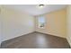 Simple bedroom featuring wood-look floors, a window, and neutral paint at 16217 Saint Augustine St, Clermont, FL 34714