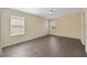 Spacious bedroom with vinyl flooring and natural light from two windows at 16217 Saint Augustine St, Clermont, FL 34714