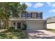 Charming two-story home featuring a well-maintained lawn and a two-car garage at 16217 Saint Augustine St, Clermont, FL 34714