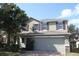 Exterior elevation of a two-story house with a two car garage and manicured landscaping at 16217 Saint Augustine St, Clermont, FL 34714