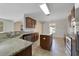 Well-lit kitchen featuring granite countertops, stainless steel appliances, and tiled flooring at 16217 Saint Augustine St, Clermont, FL 34714