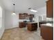 Bright kitchen with stainless steel appliances, wood cabinets, and center island at 16217 Saint Augustine St, Clermont, FL 34714