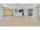 Open-concept living room with tile flooring, seamlessly connecting the living, dining, and kitchen areas at 16217 Saint Augustine St, Clermont, FL 34714