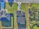 Overhead view of a newly constructed modern home with a black roof and brick paver driveway at 17135 Sw 41 Ct, Ocala, FL 34473