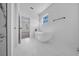 Bright bathroom featuring a freestanding tub, marble floors and white walls with natural light at 17135 Sw 41 Ct, Ocala, FL 34473