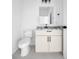 Well-lit powder room features an updated vanity and toilet with black fixtures at 17135 Sw 41 Ct, Ocala, FL 34473