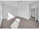 Bright bedroom featuring a large closet, soft carpet flooring, natural light and an open door to bathroom at 17135 Sw 41 Ct, Ocala, FL 34473