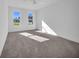 Spacious bedroom featuring soft carpet flooring, natural light from two windows and a ceiling fan at 17135 Sw 41 Ct, Ocala, FL 34473