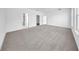 Large, carpeted bedroom with bright windows, a ceiling fan, and several doors to other rooms at 17135 Sw 41 Ct, Ocala, FL 34473