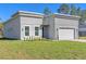 Contemporary home exterior with gray stucco, two-car garage and manicured front yard at 17135 Sw 41 Ct, Ocala, FL 34473