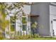 Side exterior view featuring a clean design, a modern window and a black lit front door at 17135 Sw 41 Ct, Ocala, FL 34473