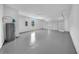 Spacious and clean garage featuring freshly painted walls and floors, along with a window for natural light at 17135 Sw 41 Ct, Ocala, FL 34473