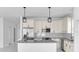 Bright kitchen featuring an island with granite countertops and pendant lighting at 17135 Sw 41 Ct, Ocala, FL 34473