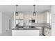 Bright kitchen with granite countertops, stainless steel appliances, and modern pendant lighting at 17135 Sw 41 Ct, Ocala, FL 34473