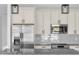 Up-close kitchen featuring stainless appliances, granite countertops, and stylish lighting at 17135 Sw 41 Ct, Ocala, FL 34473