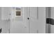 Bright laundry room features white walls, marbled tile floor, and a window view at 17135 Sw 41 Ct, Ocala, FL 34473