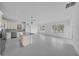 Spacious living room flows into kitchen with modern lighting and large windows at 17135 Sw 41 Ct, Ocala, FL 34473