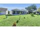 This home features a spacious, well-maintained backyard with screened patio and lush landscaping at 1817 Snaresbrook Way, Orlando, FL 32837