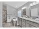 Bright bathroom featuring a soaking tub, double vanity with granite counters, and decorative mirrors at 1817 Snaresbrook Way, Orlando, FL 32837